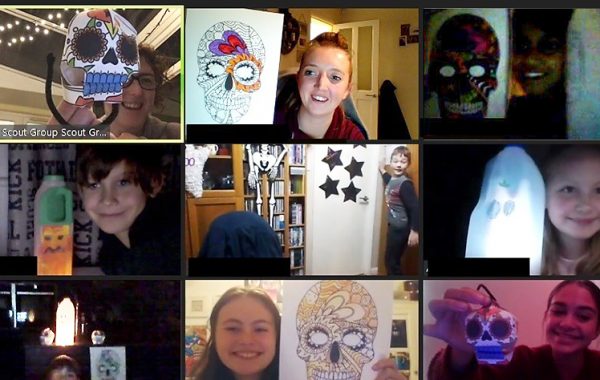 Screen shot of a Zoom session showing Cubs with paper skulls and milk carton ghosts.