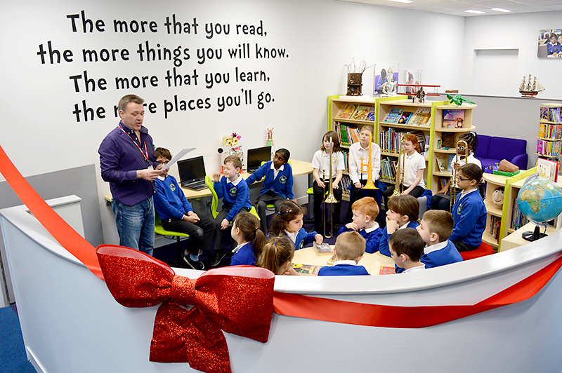 Performance poet Ian Bland recites a poem at the official opening of the new library area at Little Stoke Primary School.