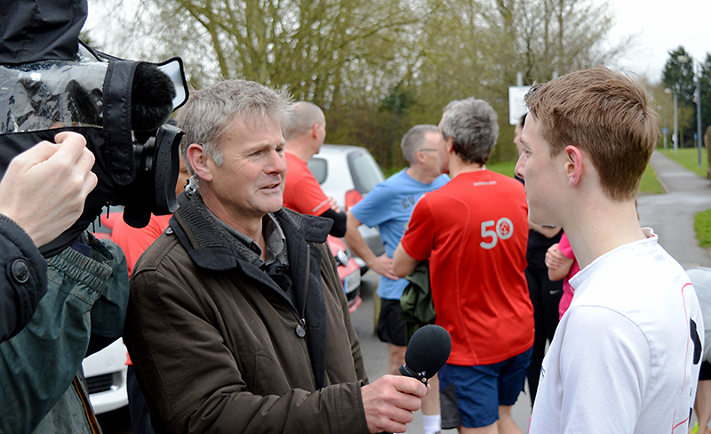 A BBC reporter interviews a runner in Little Stoke Park on the morning of the cancelled parkrun on 16th April 2016.