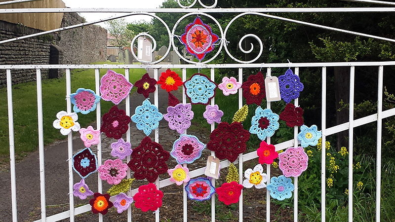 Yarn bombing on the gate leading to Parkway Station by St Mike's Yarn Bombers (SMYB).