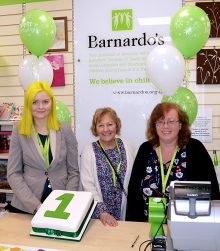 Photo of staff and volunteers at Barnardo's in Stoke Gifford, with a first anniversary cake.