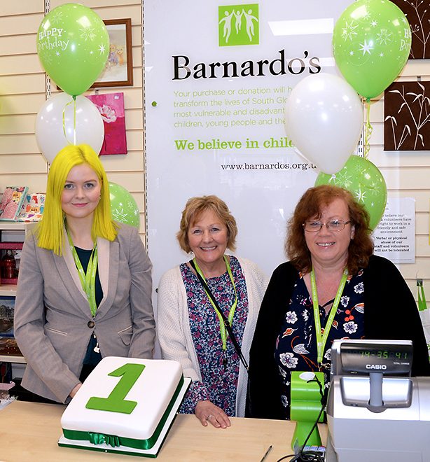 Photo of staff and volunteers at Barnardo's in Stoke Gifford, with a first anniversary cake.