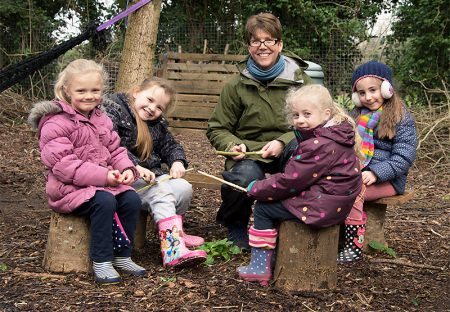 A group of children enjoy a Forest School session with Jenny Ratcliffe.
