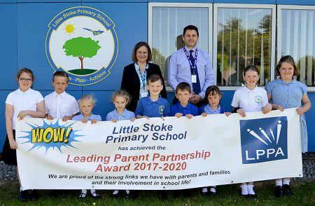 Photo of staff and pupils at Little Stoke Primary School standing behind a LPPA banner.