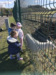 Children from the local community visiting the goats.