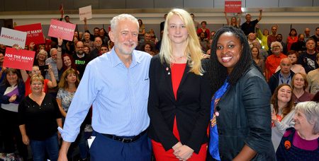 Photo of Jeremy Corbyn, Mhairi Threlfall and Dawn Butler on stage at the St Michael's Centre, with enthusiastic supporters in the background.