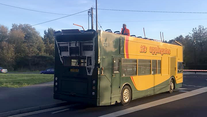 Photo of double decker bus without its roof.