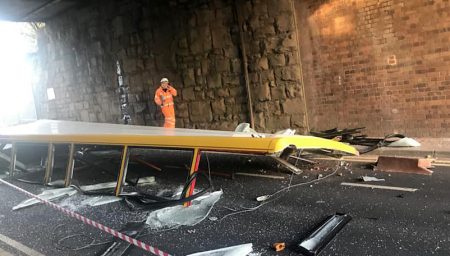 The roof of a bus lies in the carriageway under the Parkway railway bridge following a bridge strike incident.