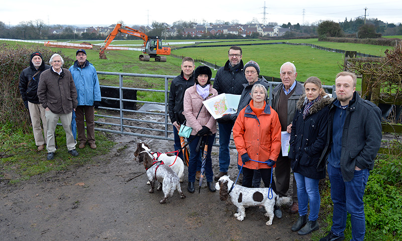Photo of concerned residents gathered at a field gate near the junction of Westfield Lane and Harry Stoke Road.