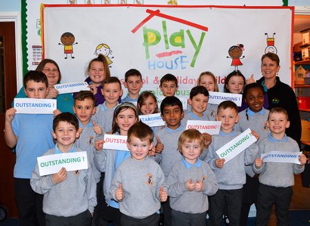 Photo of staff and children at Play House Afterschool & Holiday Club celebrating their recent 'outstanding' Ofsted grading.