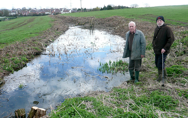 Photo of Adrian Kerton (right) and local resident David Shore at the ‘moat’.