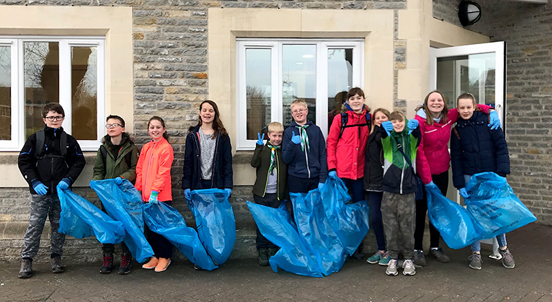 Photo of Scouts gathered outside The Old Schools Rooms prior to the start of their litter-picking walk.