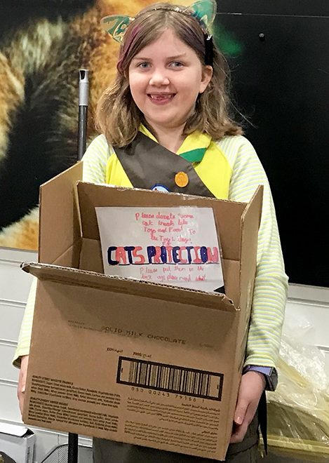 Photo of Ruth delivering a box of donations to the charity shop in Bedminster.