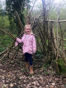 Photo of a child exploring in the wood.