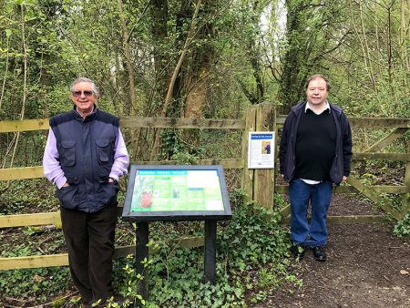 Photo of conservation group members Fred Hillberg (left) and David Bell at the entrance to the wood.