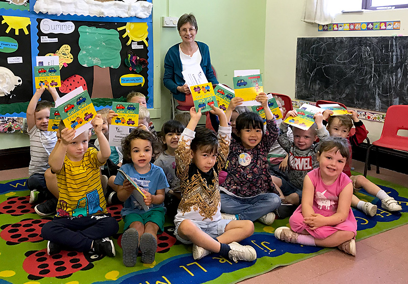 Photo of a Bookstart Pyjamarama event taking place at Abacus Pre-School, led by a volunteer from Stoke Gifford Community Library.