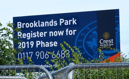 Photo of a sign advertising Crest Nicholson's Brooklands Park housing development.