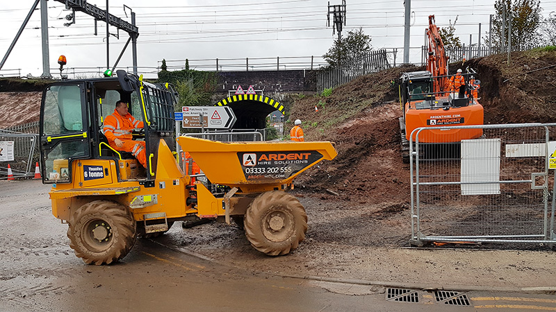 Photo of an excavator preparing the embankment for piling.