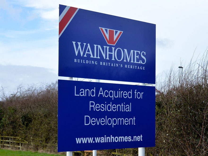 Photo of a Wainhomes 'Land acquired' sign'.