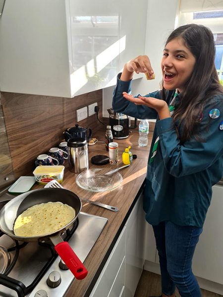 Photo of a Scout making pancakes.