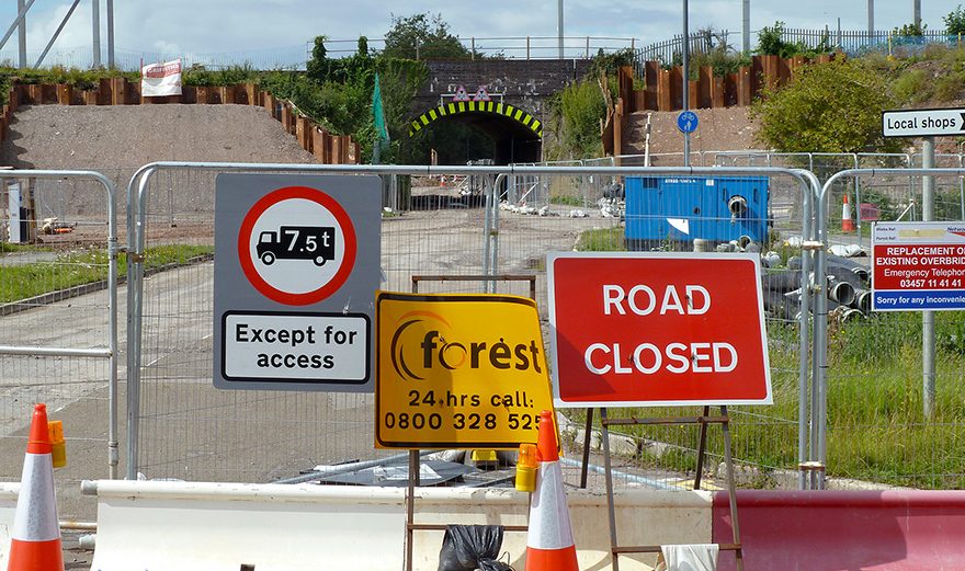 Photo of road closure signs and barriers.