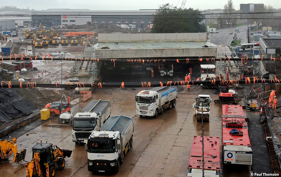 Photo of tarmac being laid underneath the front part of the bridge.