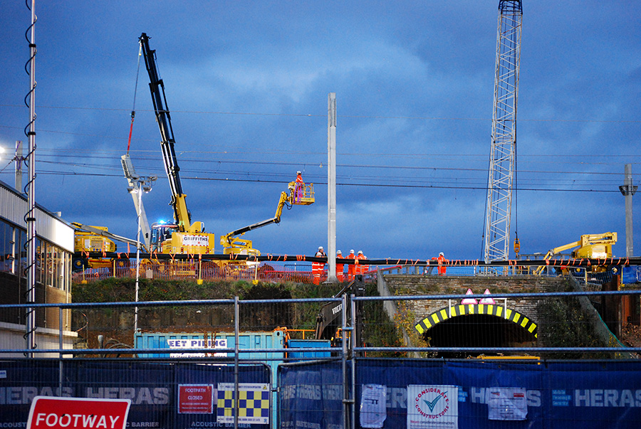 Photo of workers removing overhead line equipment.