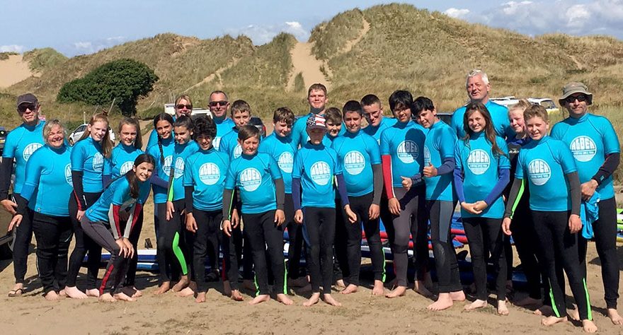 Photo of a large group of Scouts on a beach.