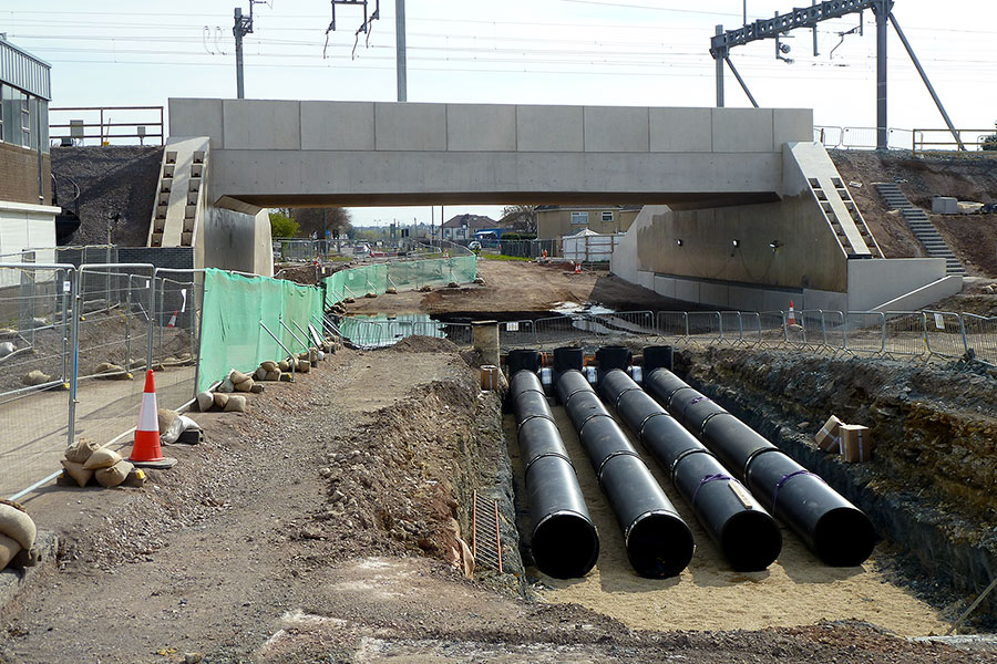 Photo of bridge and huge drainage pipes.