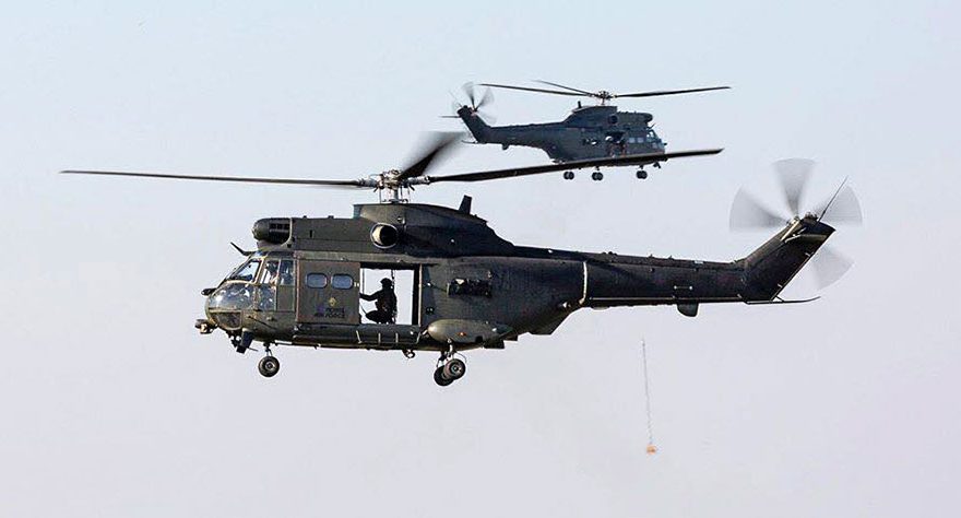 Photo of two helicopters in flight.