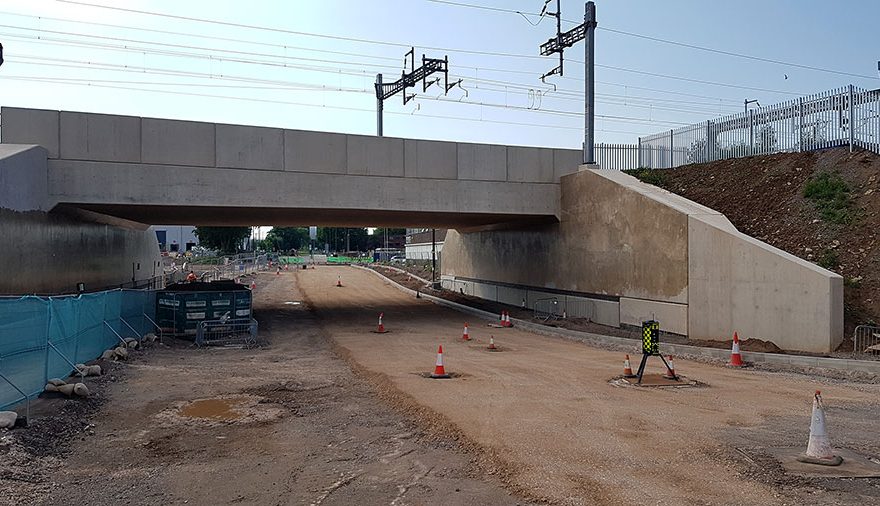 Photo of a railway bridge with partly prepared road surface underneath.