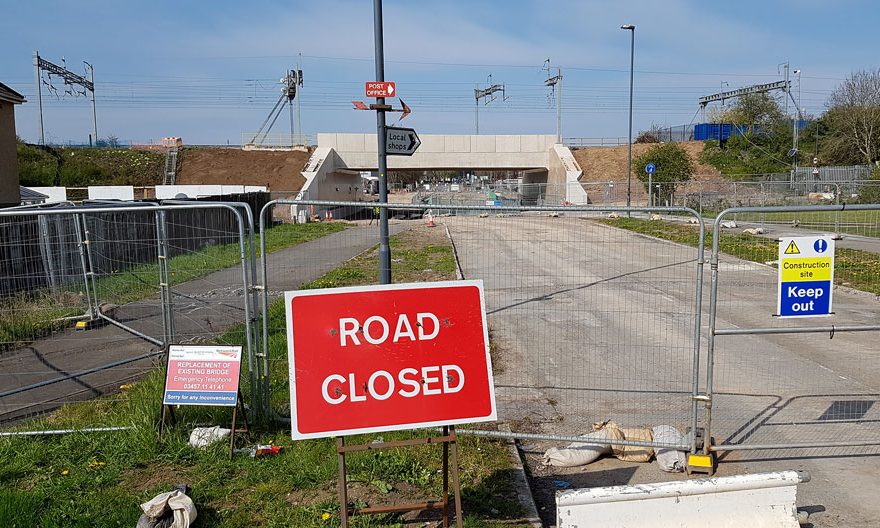 Photo of a 'road closed' sign in front of a bridge.