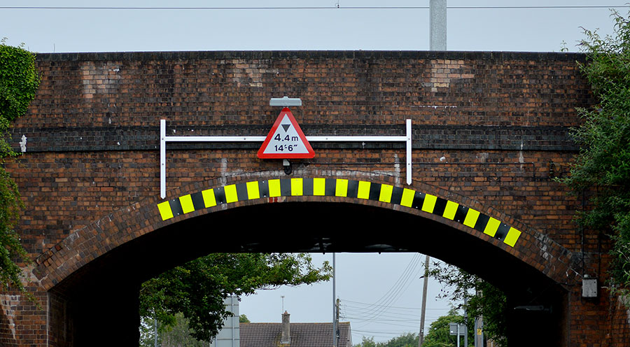 Photo of a bridge with height warning signage.