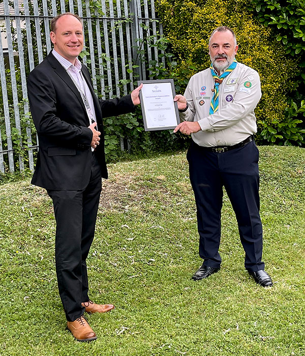 Photo of two men holding a framed certificate.