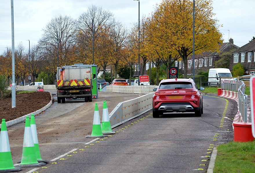 Photo of highway works taking place alongside a live traffic lane.