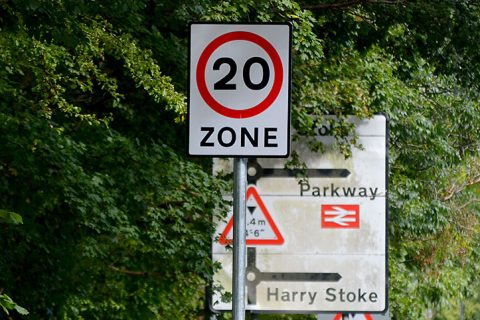 Photo of a 20mph road sign, amongst other signs.