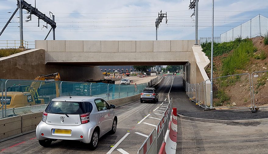 Photo of cars passing a sealed-off side road.