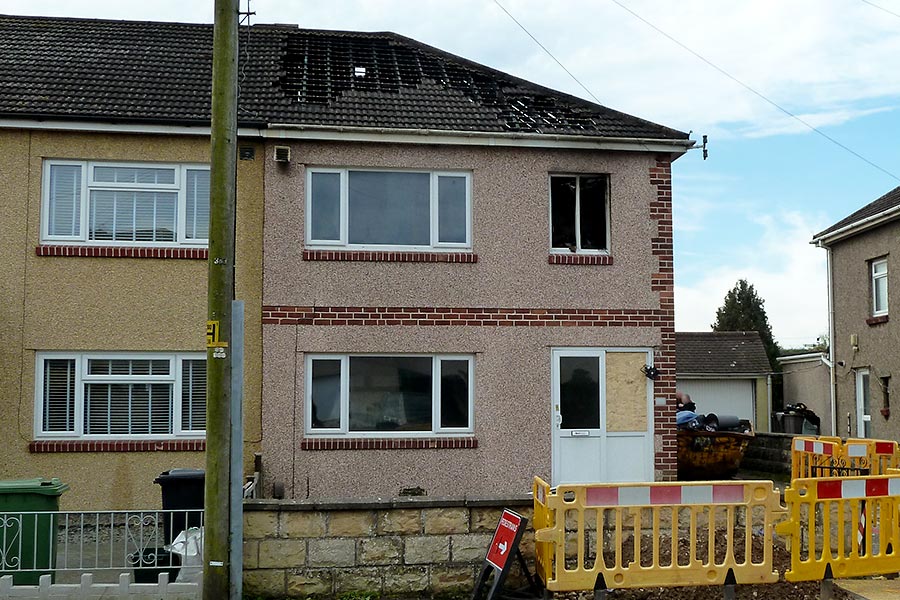 Phot of a fire-damaged house.