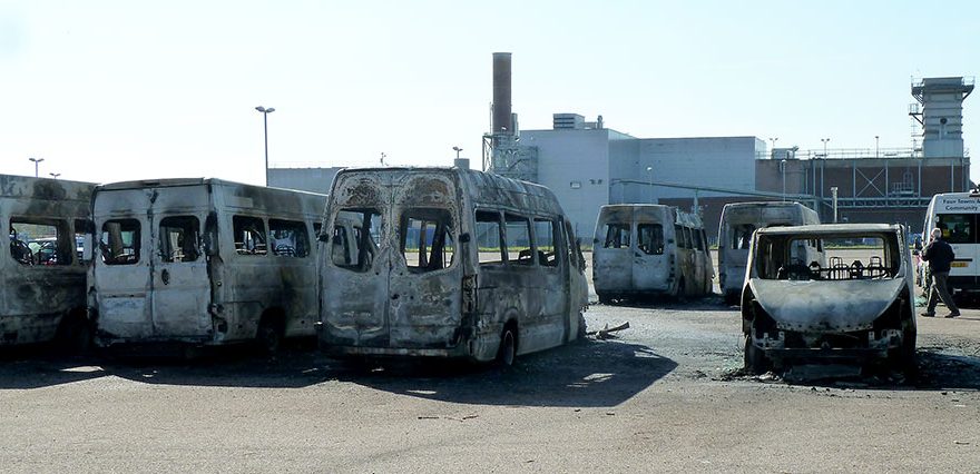 phot of several fire-damaged minibuses.