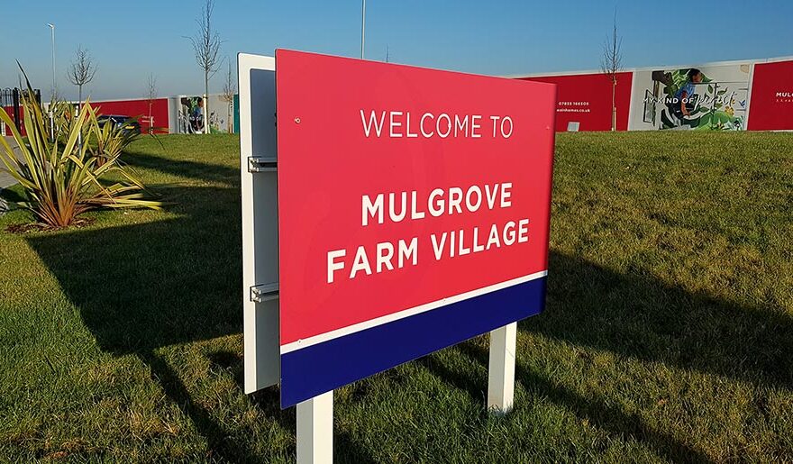 Photo of a sign displaying the words 'Welxome to Mulgrove Farm Village'.
