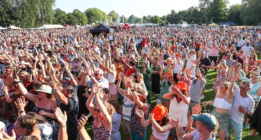 Photo of the crowd at an open-air music event.