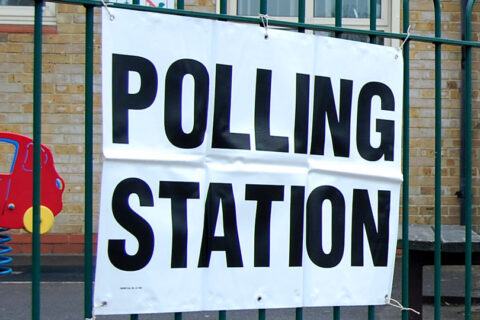 Photo of a sign displaying the words 'polling station'.