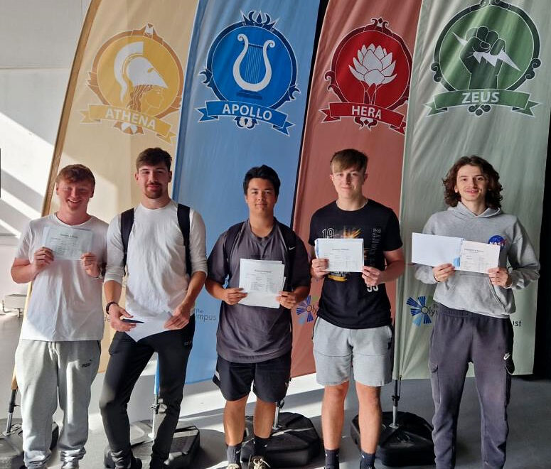 Photo of a group of students holding envelopes.