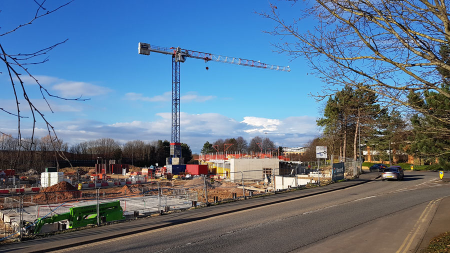 Photo of large crane within a building site.